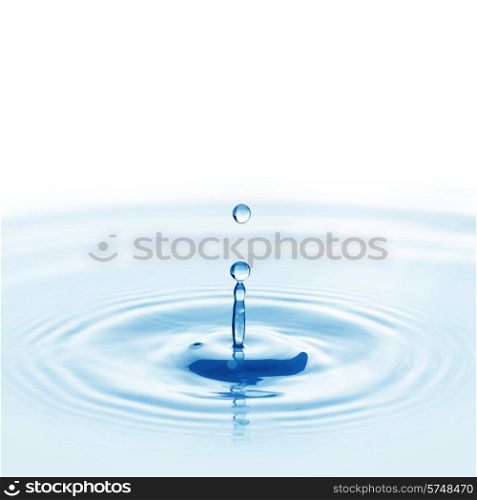 Water drop falling into water making a perfect droplet splash. Falling water drop
