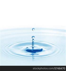 Water drop falling into water making a perfect droplet splash. Falling water drop