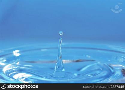 water drop hangs over water surface