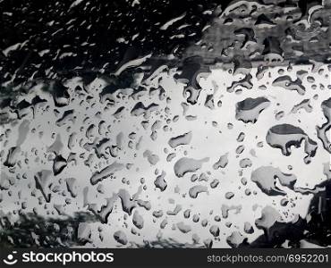 Water Drop on the Hood of the Car. Rain Drops on the Surface of the Car or on the Iron Surface Flow Down. Abstract Background and Water Texture for Design.