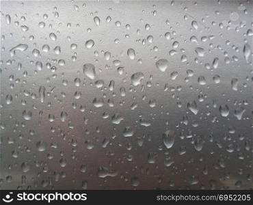 Water Drop on the Hood of the Car. Rain Drops on the Surface of the Car or on the Iron Surface Flow Down. Abstract Background and Water Texture for Design.