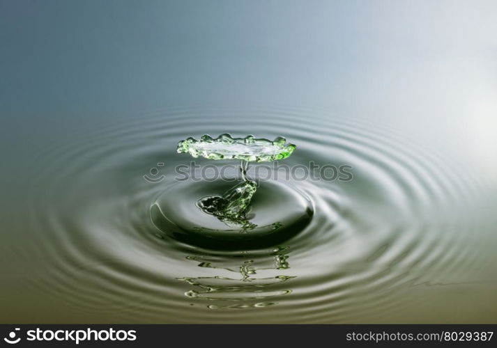 Water drop photography, one or two drops of water dropped from height into a tray filled with water and captured as they hit the water or collide with each other.