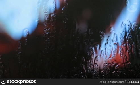 Water drops moving down on window.