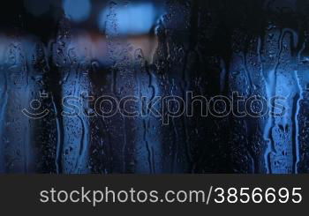 Water drops moving down on window.