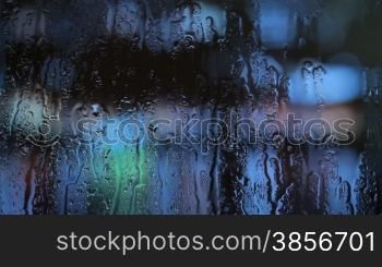 Water drops moving down on window.