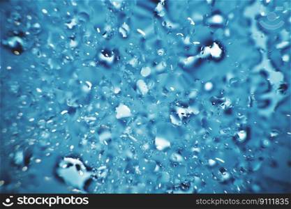 water drops on a blue background. Abstract blue background. Water drops on glass. Natural background toned in blue.. water drops on a blue background. Abstract blue background. Water drops on glass.