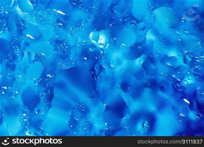 water drops on a blue background. Abstract blue background. Water drops on glass. Natural background toned in blue.. water drops on a blue background. Abstract blue background. Water drops on glass.