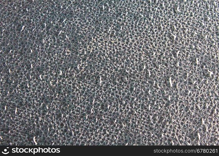 water drops on a dark surface, texture of plastic