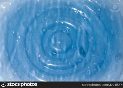 Water drops on acrylic plate top of blue basin
