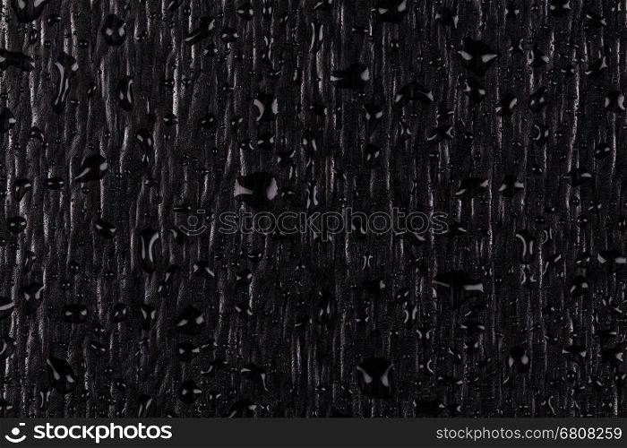 Water drops on dark stone surface texture background