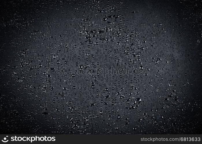 Water drops on dark stone surface texture background