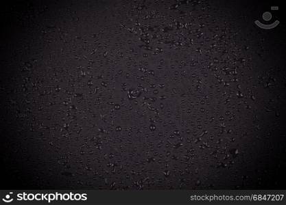 Water drops on dark stone . Water drops on dark stone surface texture background