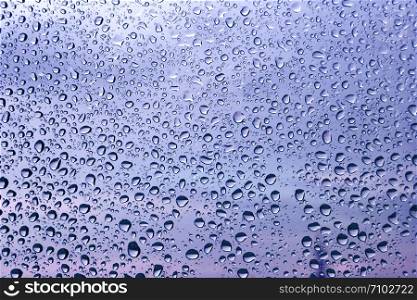 Water drops on glass, close-up natural texture
