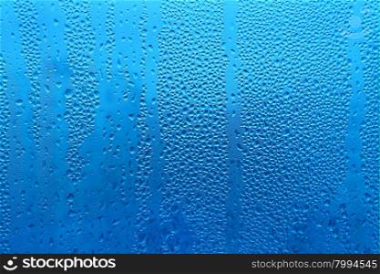 Water drops on glass naural blue texture