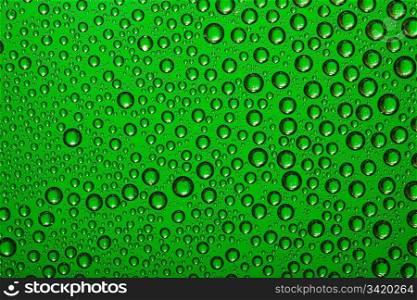 Water drops on green glass
