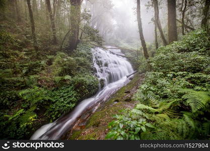 Water flowing at a beautiful waterfall at Inthanon nation park, Chiangmai, Thailand. Long exposure photography.. Water flowing at a beautiful waterfall at Inthanon nation park, Chiangmai, Thailand.