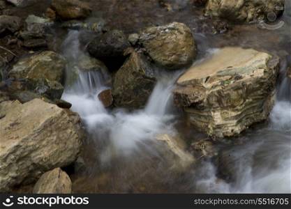 Water flowing through rocks, Macaw Mountain Bird Park, Copan, Copan Ruinas, Copan Department, Honduras