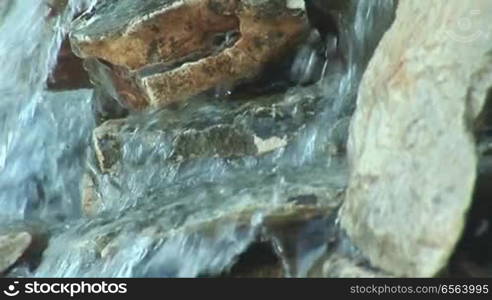 Water flows over a stone wall