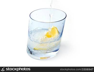 Water glass with ice & lemon isolated on white