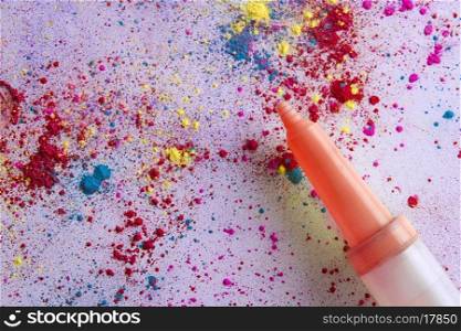 Water gun on colorful powder paint spread over white background