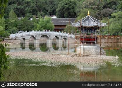 Water in the pond after drought and pagoda in Lijing, China