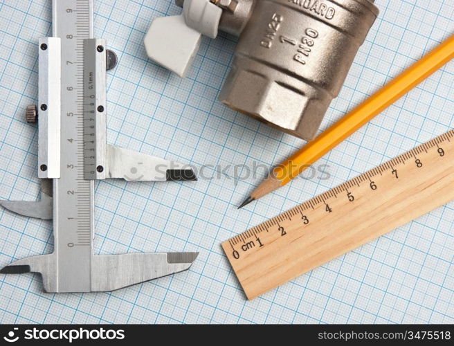 water inlet valve on a background of graph paper