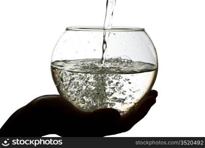 Water is poured into a large glass