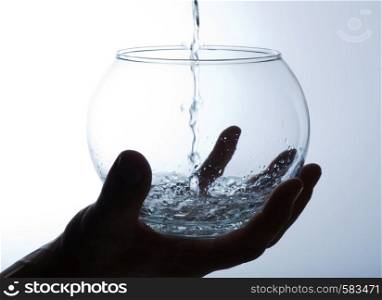 Water is poured into a large glass