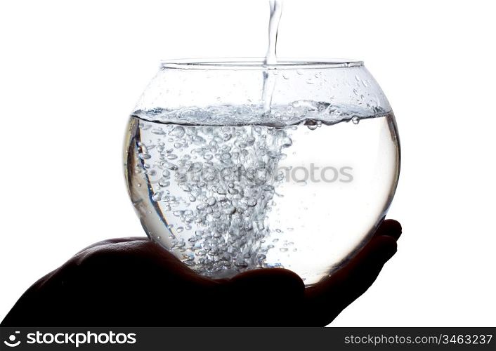 Water is poured into a large glass isolated on white background