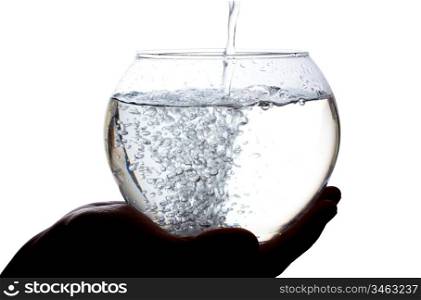 Water is poured into a large glass isolated on white background