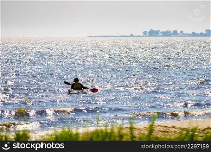 Water lake shore and person kayaking. Water shore and person kayaking