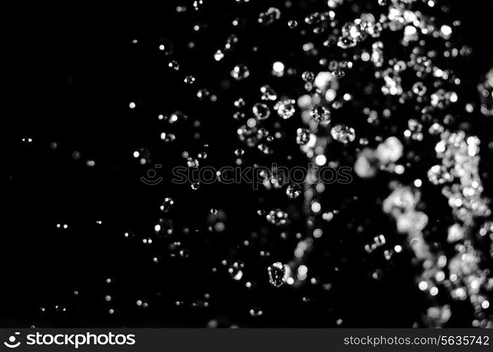 Water levitation with defocused lights on background.
