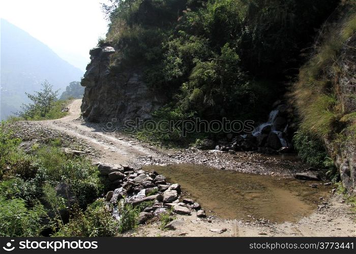 Water on the road near rock in mountain, Nepal