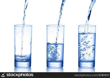 water pouring in a glass on white background