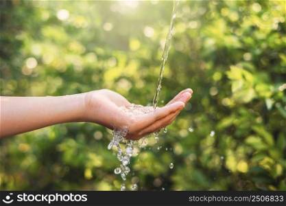 Water pouring on hand in morning ligth background