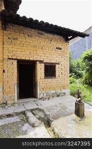 Water pump in front of a house, Yangshuo, Guangxi Province, China