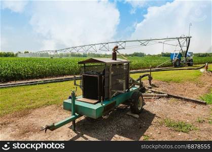 Water pump with diesel engine, soybean field, crop irrigation using the center pivot sprinkler system.