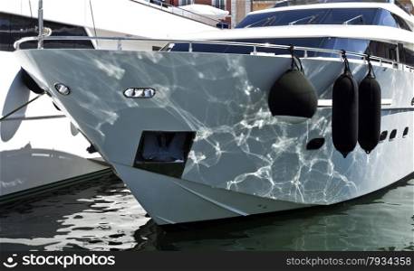 Water reflections on the bow of a super yacht moored at the port of St Tropez, France