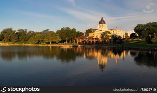 Water reflects the American Flag waving in front of the capitol dome in Pierre, SD