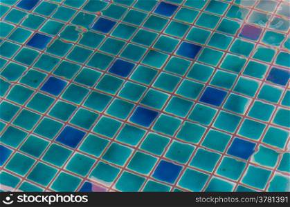 water ripples of swimming pool. reflection on the blue clear water ripples of swimming pool with mosaic bottom