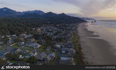 Water Rolls up onto the beach at sunset in a popular Oregon coastal town