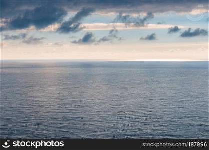 Water smooth surface of the sea, horizon and gloomy sky laconic landscape