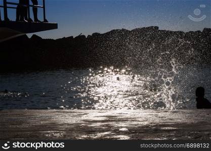 Water Splash: Child Jumping from Board into Water, Summer Fun
