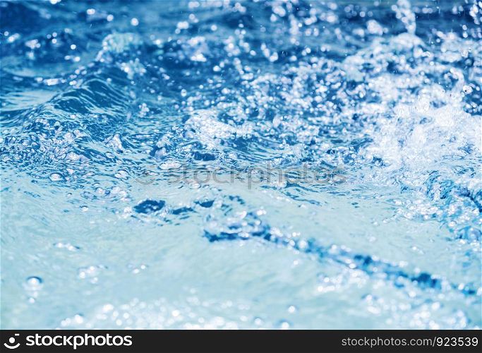 Water splash in swimming pool summer background