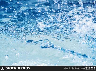 Water splash in swimming pool summer background