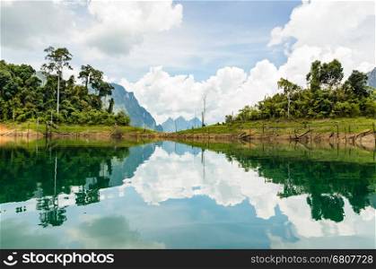 Water surface reflecting sky and cloud at Ratchapapha dam in Khao Sok National Park, Surat Thani province, Guilin of Thailand.