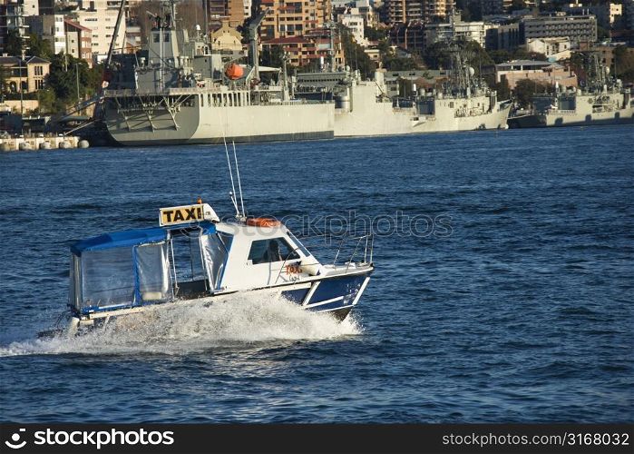 Water taxi and view of buildings and boats in Sydney, Australia.