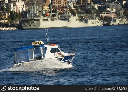 Water taxi and view of buildings and boats in Sydney, Australia.