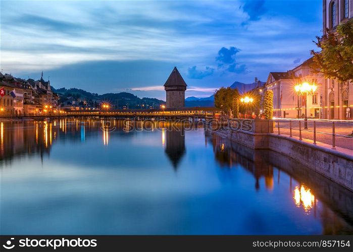 Water Tower, Wasserturm, and Chapel Bridge, Kapellbrucke over the river Reuss at night in Old Town of Lucerne, Switzerland. Lucerne at night, Switzerland