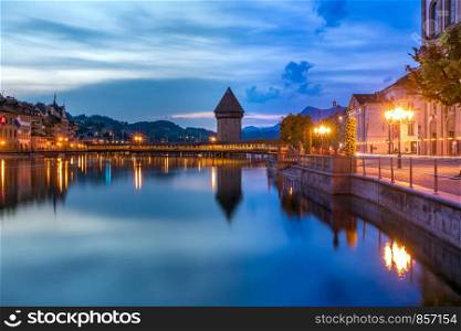 Water Tower, Wasserturm, and Chapel Bridge, Kapellbrucke over the river Reuss at night in Old Town of Lucerne, Switzerland. Lucerne at night, Switzerland
